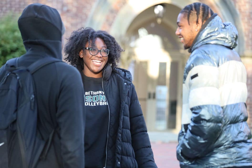 yearbook photo from the past with students on fire truck in black in white