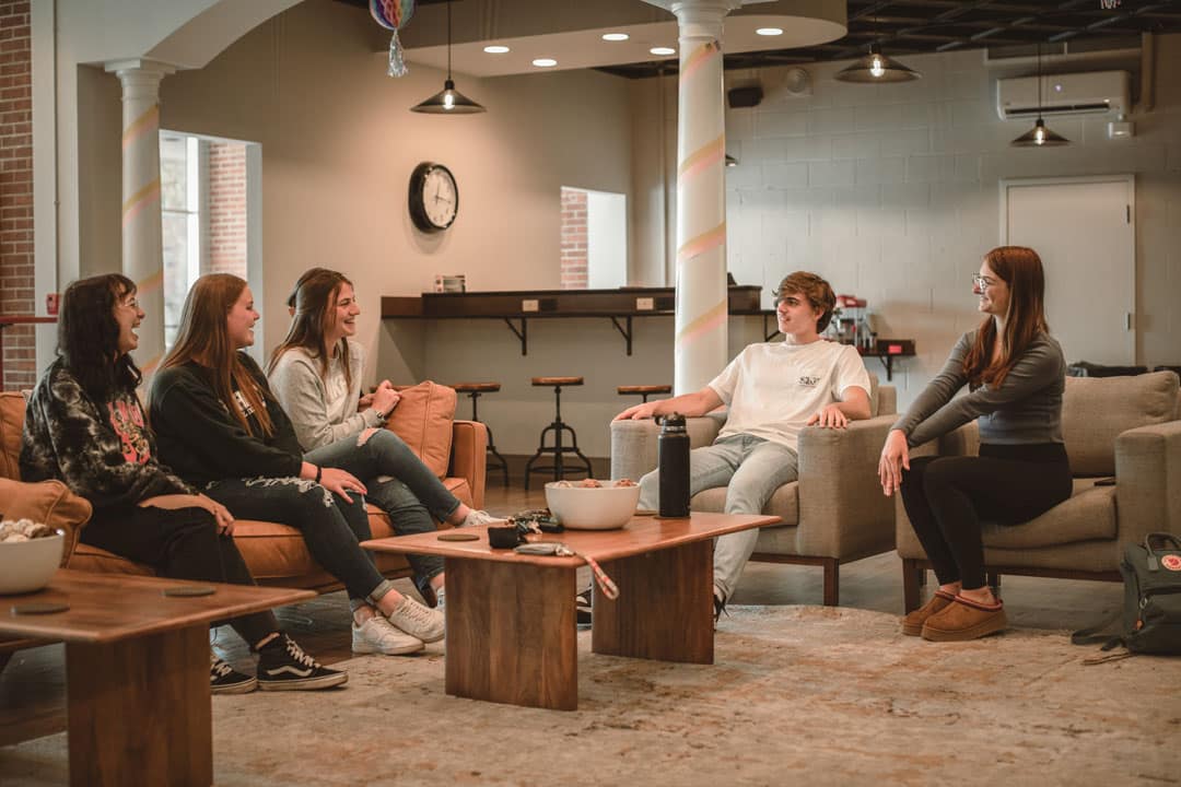 students talking in chairs and couches