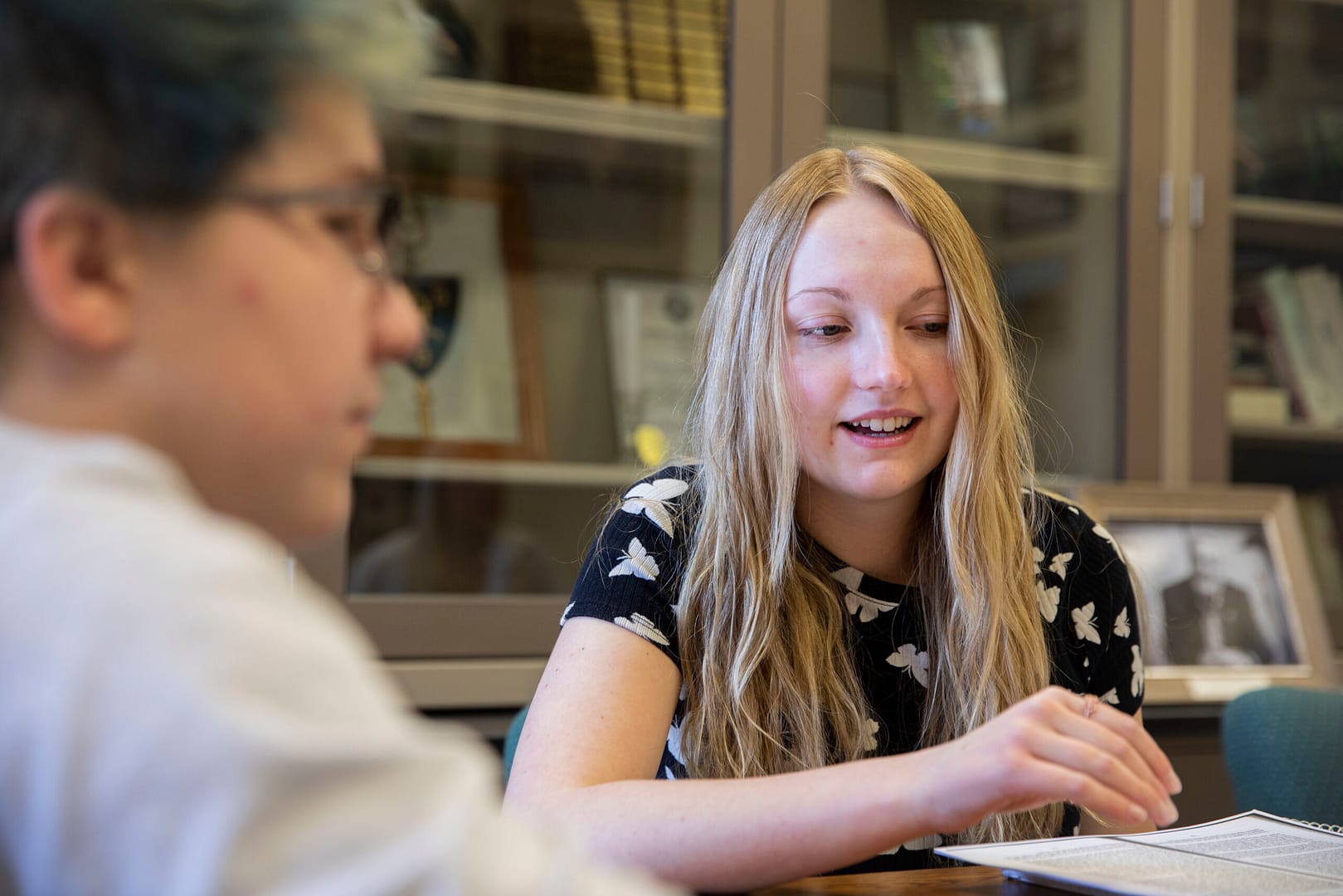 students walking and smiling in front of building