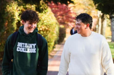 students talking on sidewalk