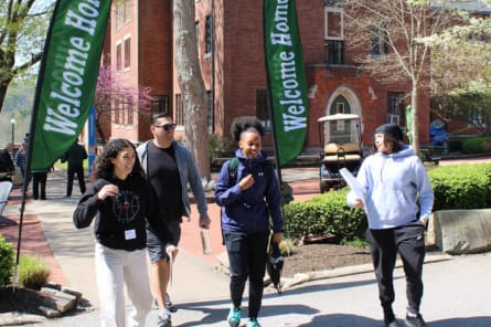 students talking on hiking path bridge