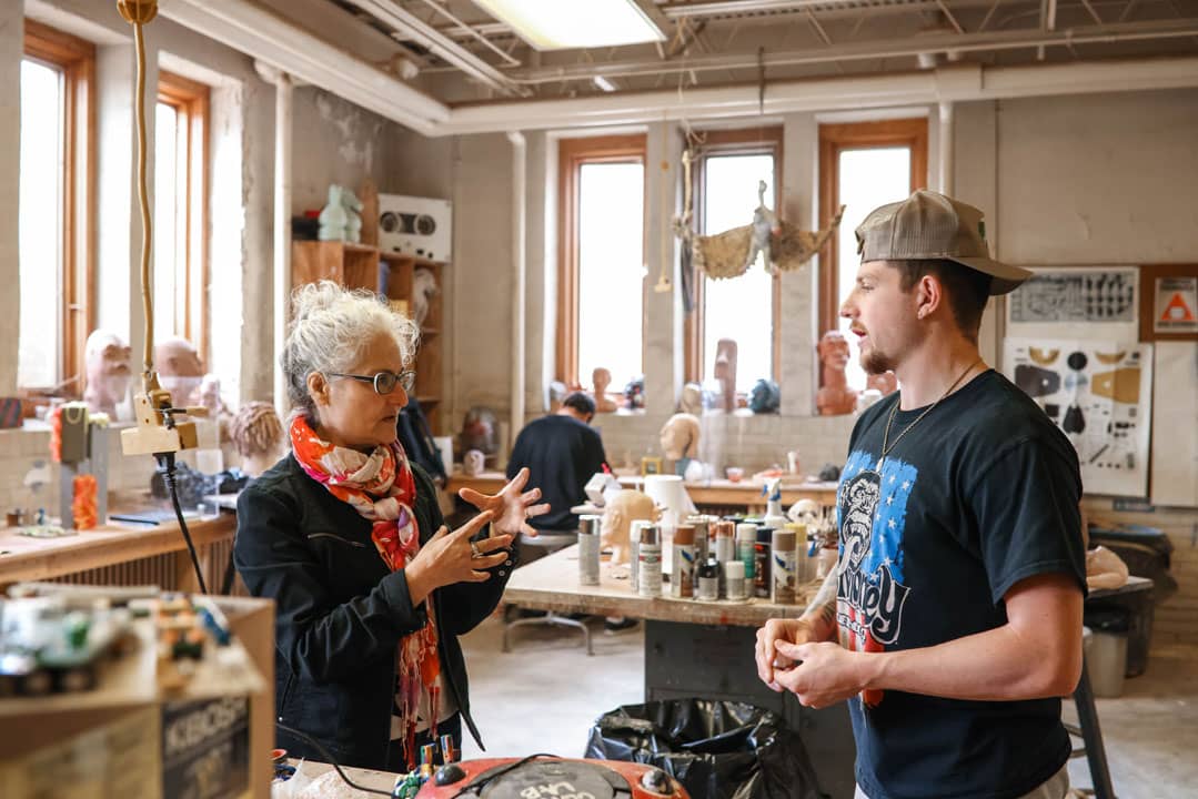 professor teaching art to a student