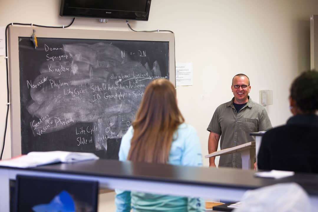 professor teaching from a blackboard