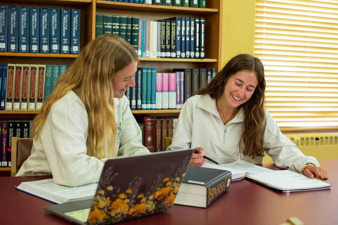 students laughing in the library