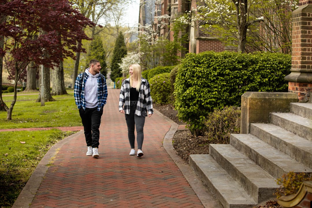 students talking on sidewalk