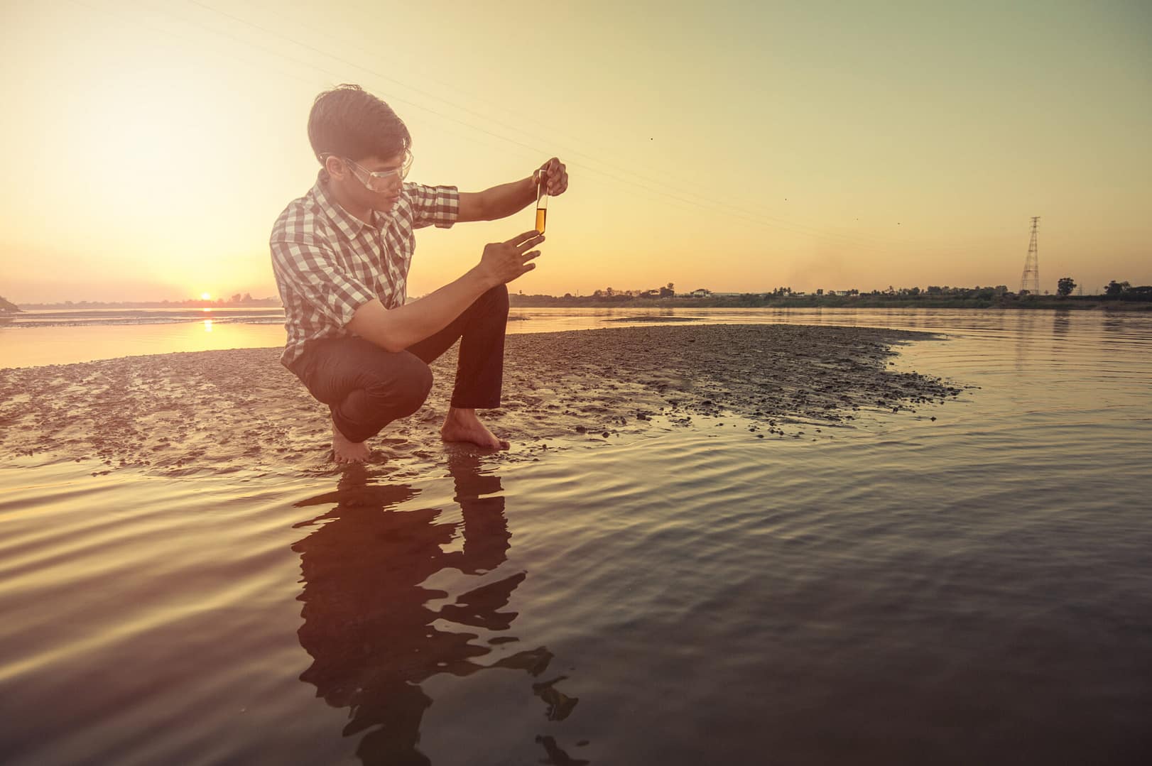 Scientist or biologist working on water analysis near the river.